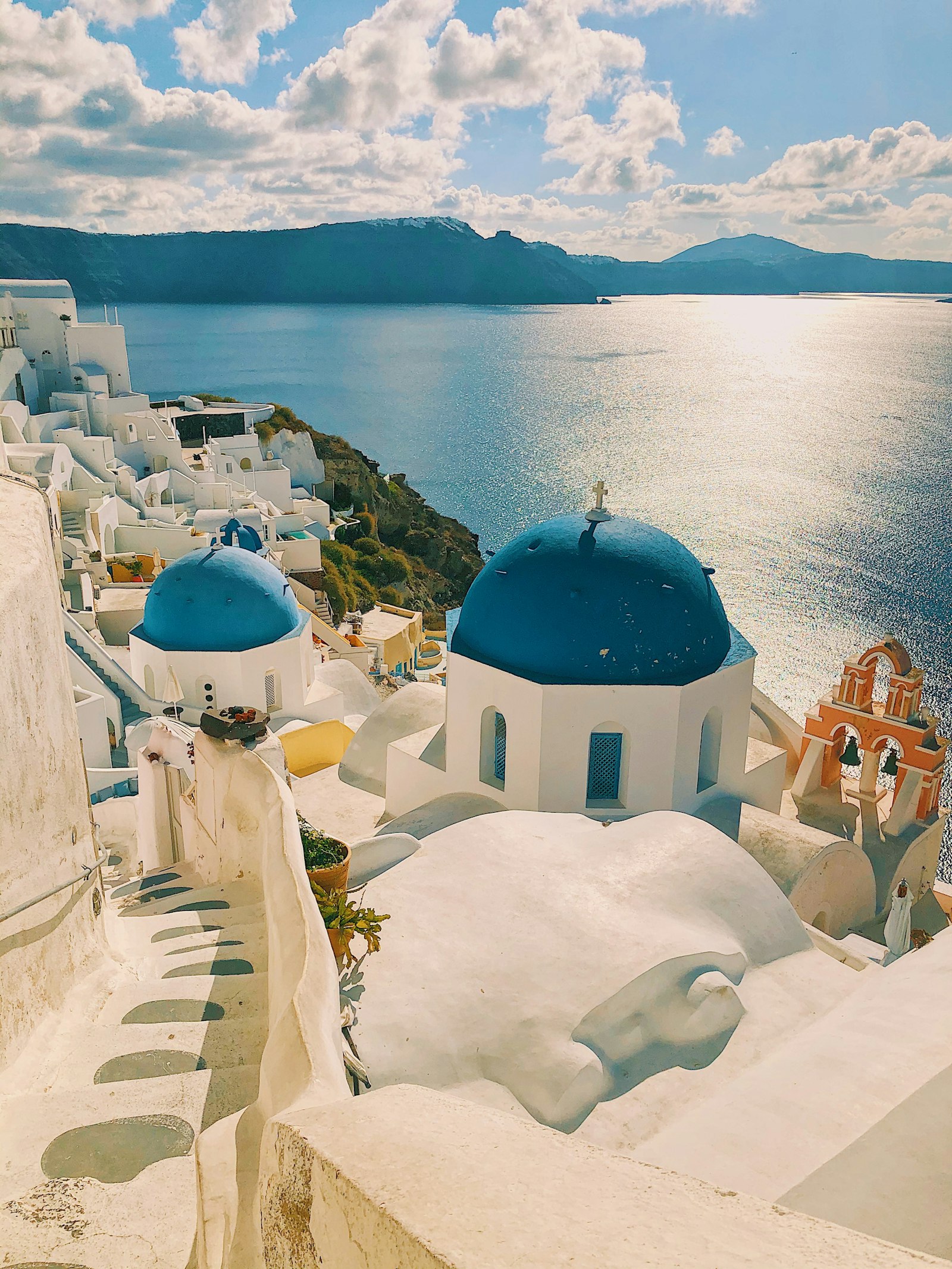 White cliffside buildings above a deep blue sea