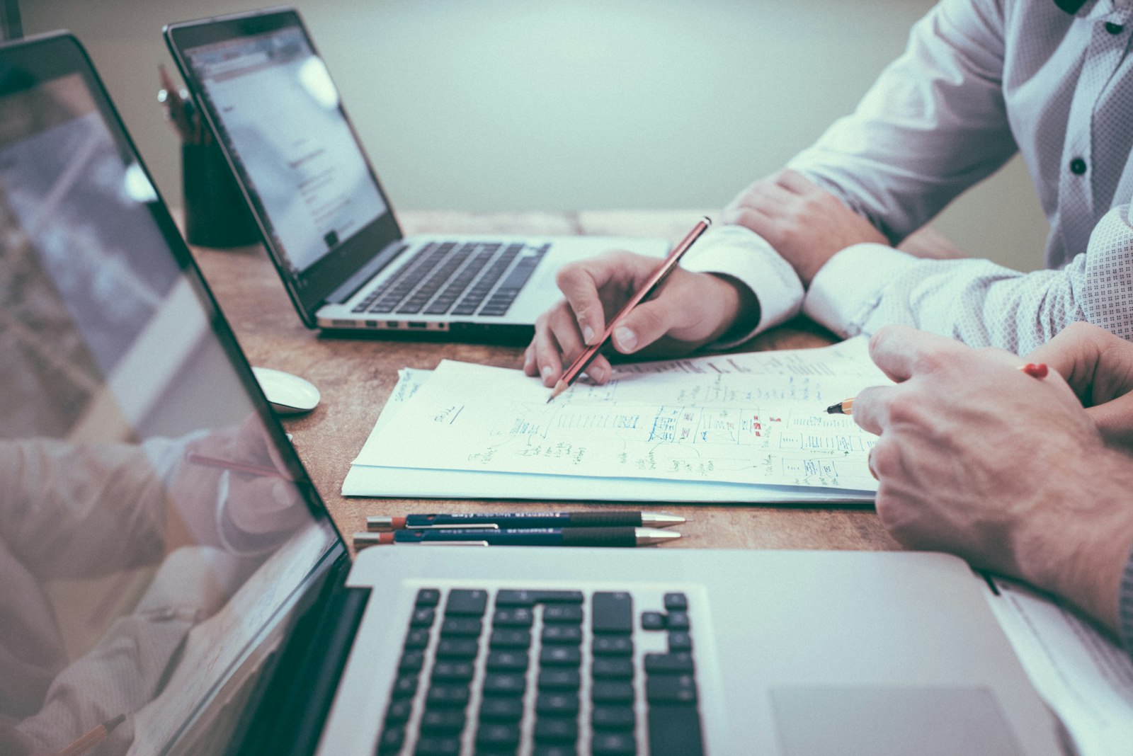 Advisers working through documents in a bright office